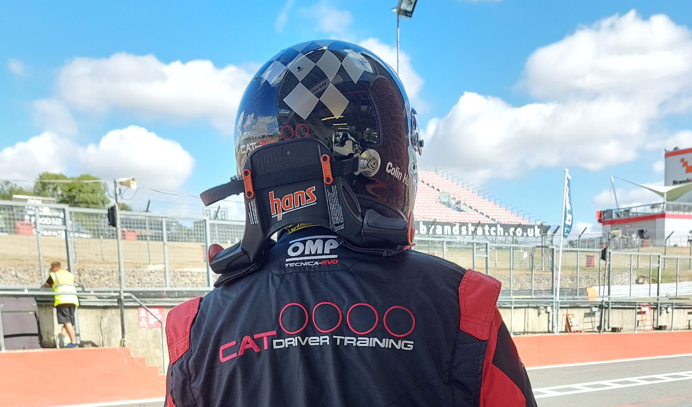 Racing Driver In Pits Wearing Hans Device