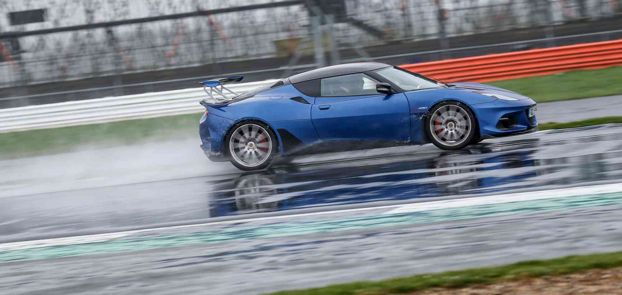 Blue McLaren on wet SIlverstone circuit